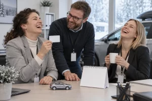 Three fictional adult vehicle service administrators clearly laughing beside a blank card and toy car during DVLA holiday opening hours planning.
