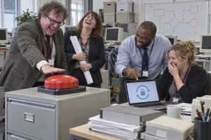 Four fictional civil servants laugh beside an oversized red panic button and abstract password icon.