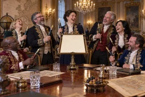 Fictional European officials laugh around a blank parchment while holding oversized fountain pens in an ornate summit room.