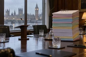 Original editorial photograph of paperwork wearing glasses for Evaluation Task Force conference 2026