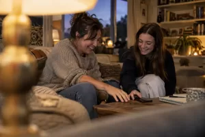 Laughing parent and teenager in fictional healthy screen use guidance children 2026 editorial photograph