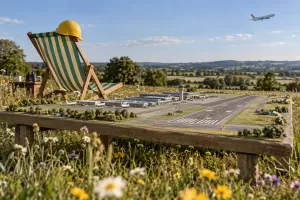 Tiny airport model and deckchair for fictional Heathrow expansion consultation 2026 editorial photograph