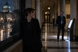 Two laughing public-service transformation staff at fictional Northern Ireland public service transformation 2026 civic building