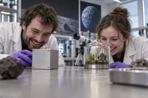 Two laughing researchers for space worms Petri Pod