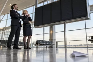 Two laughing operations staff for summer holiday flight disruption plans